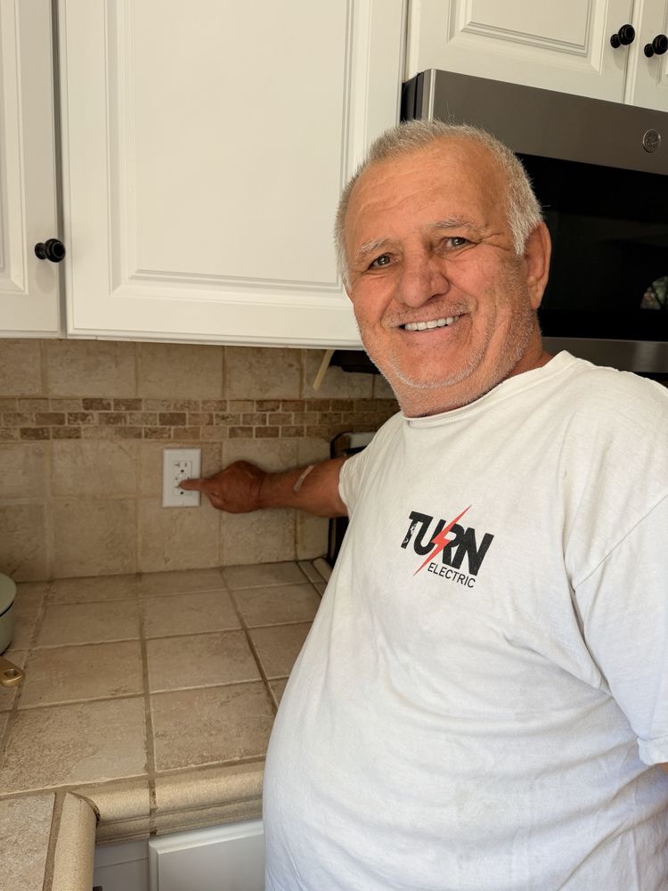 Turn Electric electrician completing an outlet installation